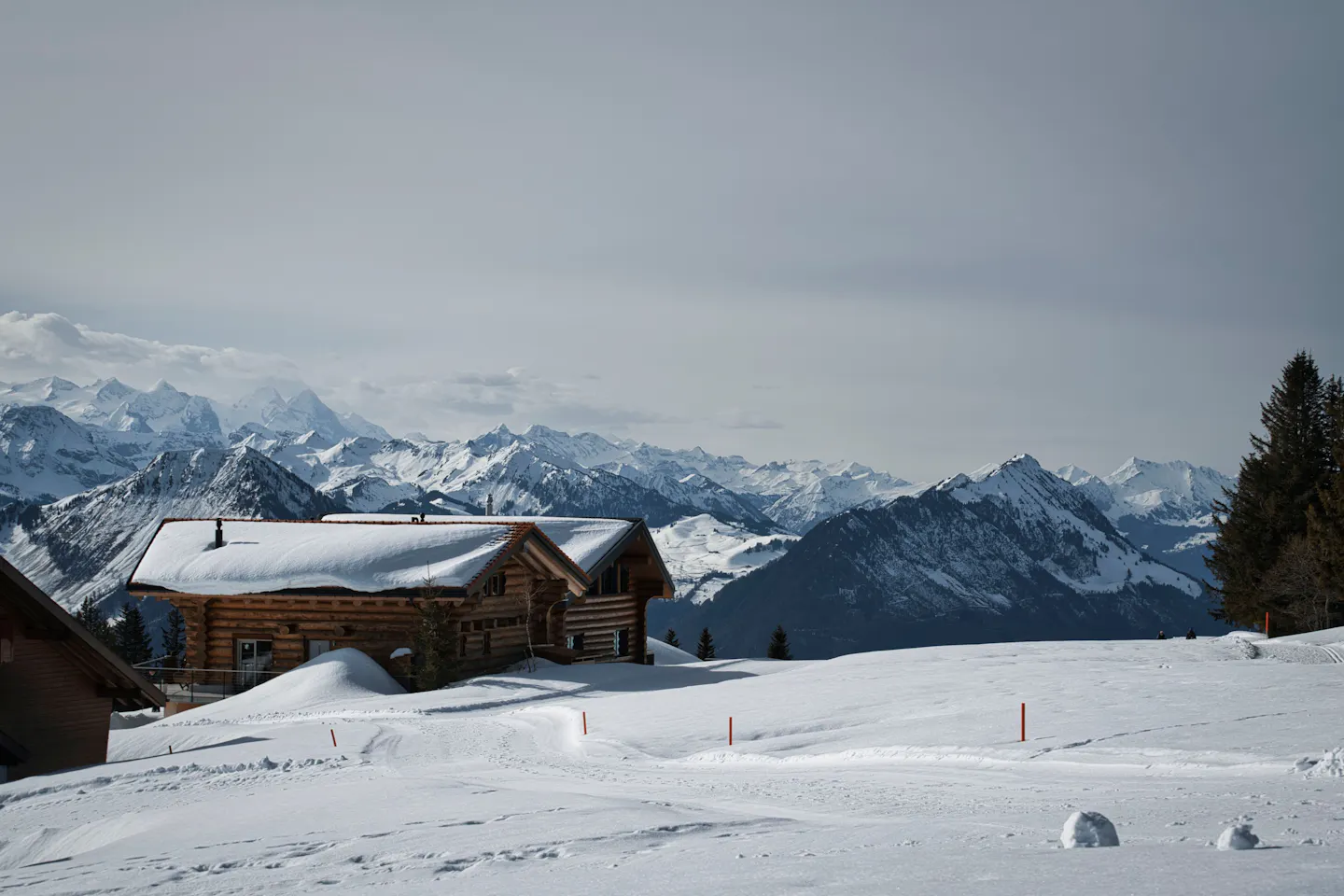 Snow-covered chalet beneath the Alps in Gstaad, Switzerland