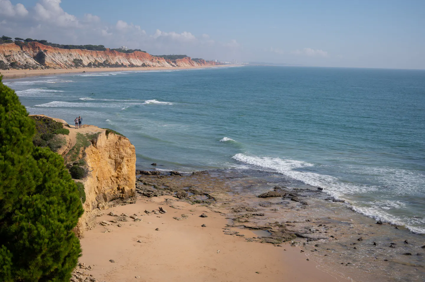 Golden limestone cliffs and a quiet beach along Portugal’s Algarve coast