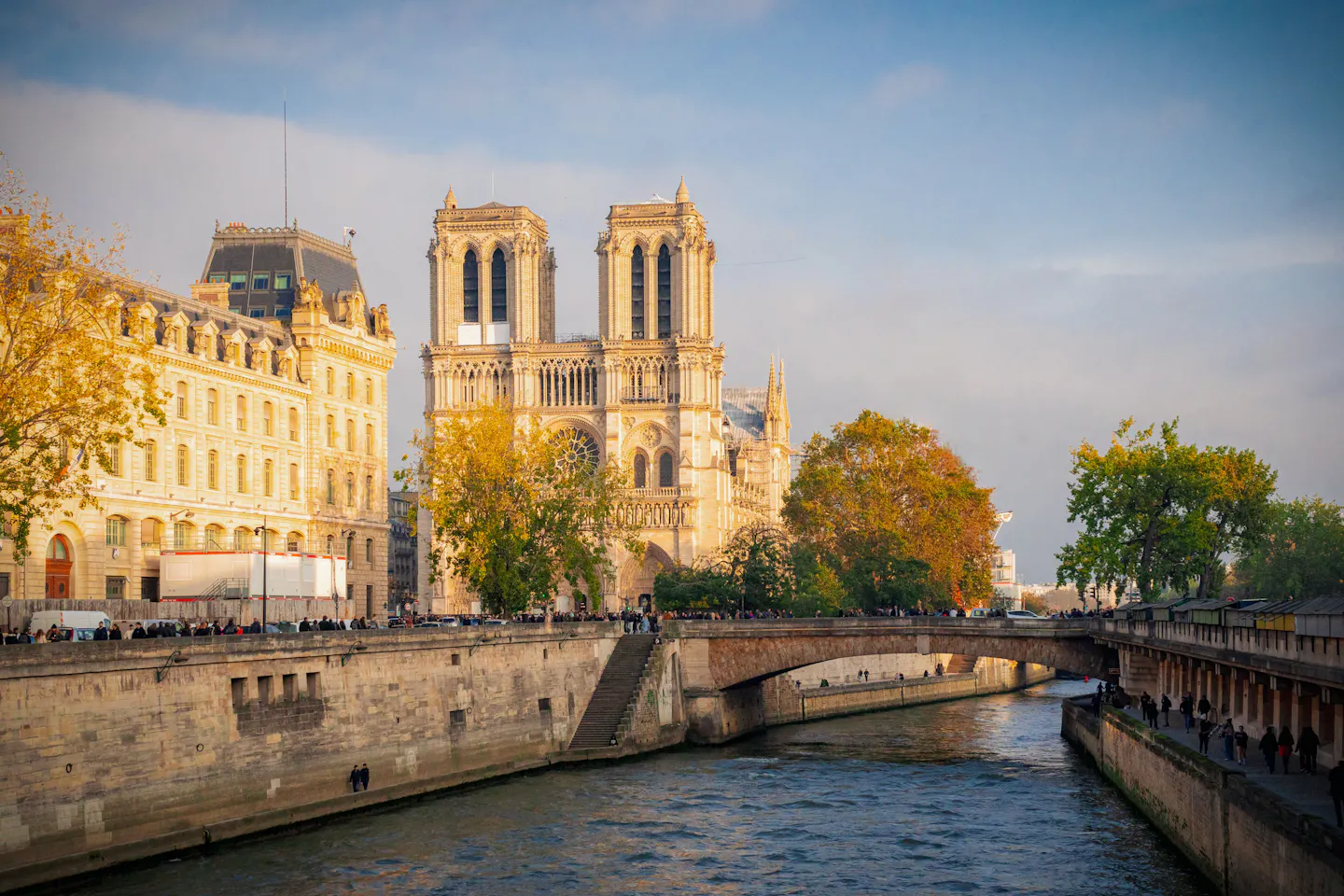 The towers of Notre-Dame rising above the Seine in warm autumn light