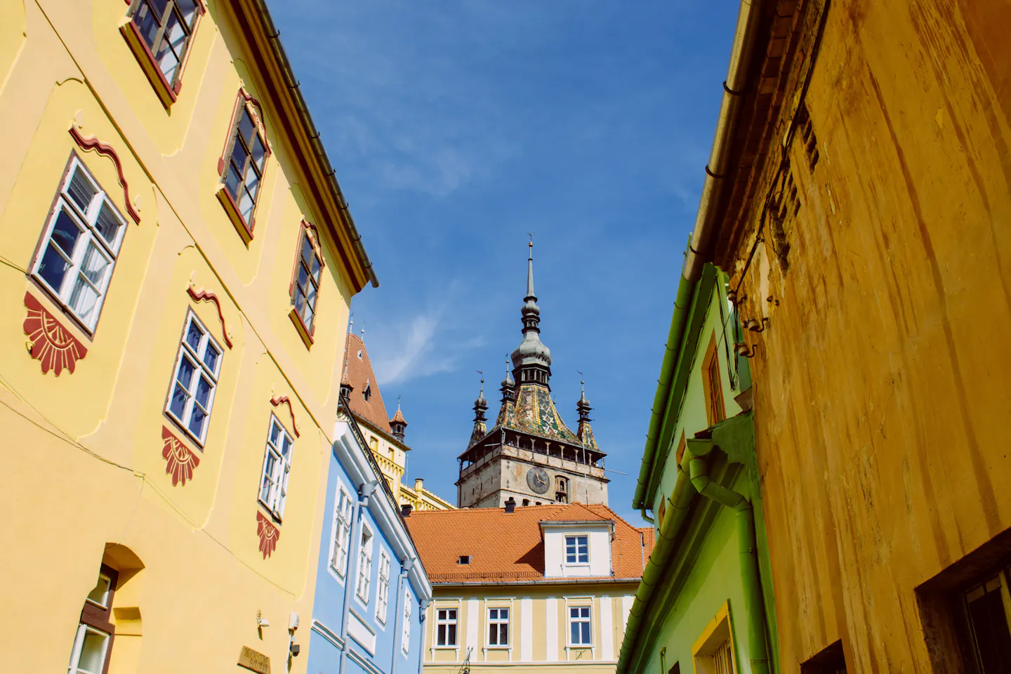A colourful old lane in Sighișoara, Transylvania, leading toward the medieval Clock Tower
