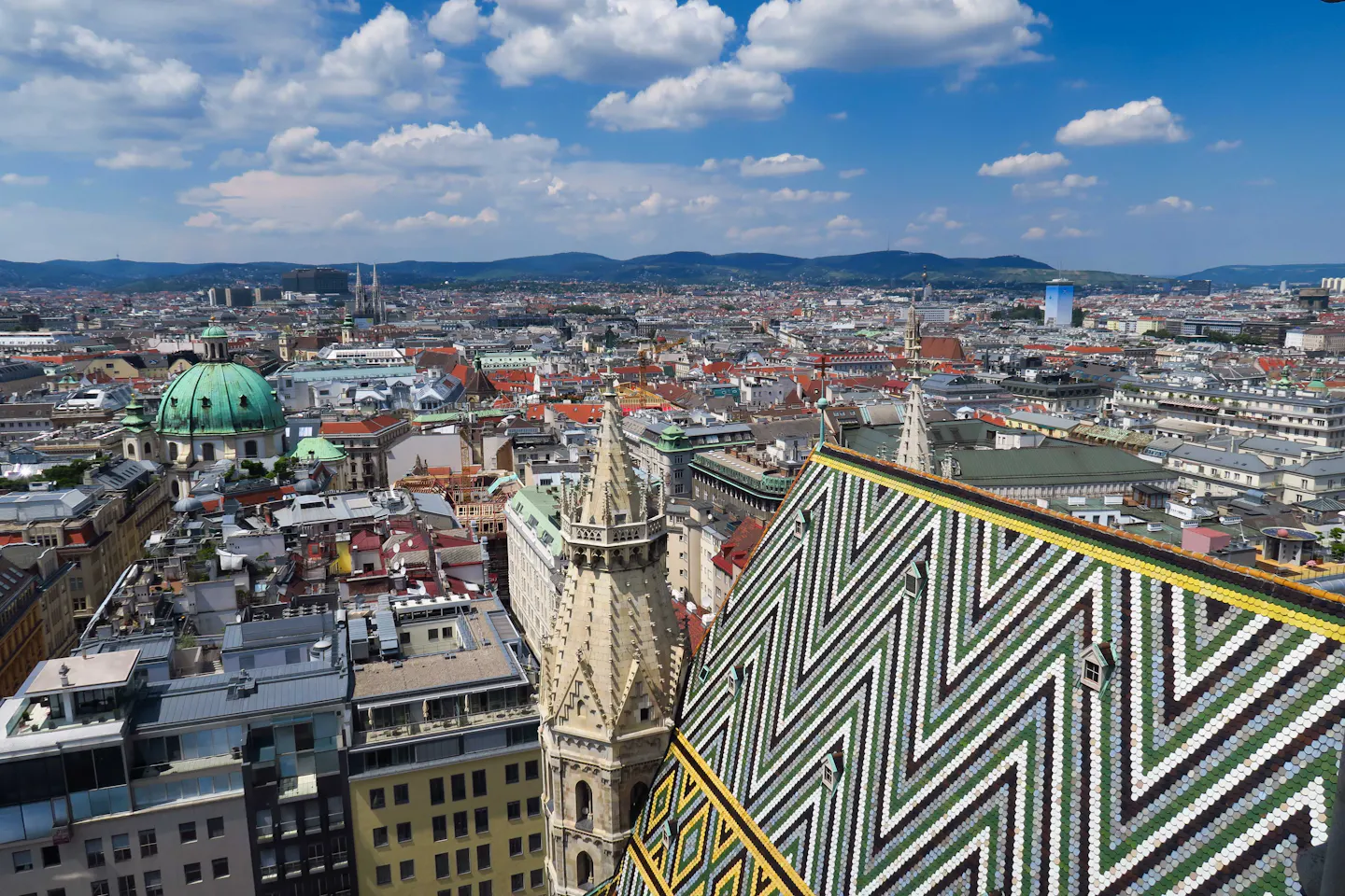 The patterned tile roof of St Stephen's Cathedral above the rooftops of central Vienna