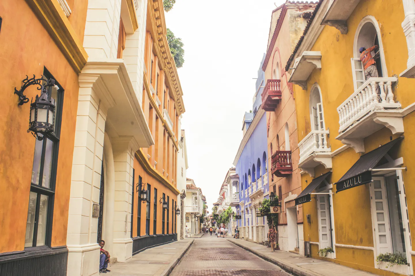 Colorful colonial street in Cartagena, Colombia, lined with balconies and pastel façades