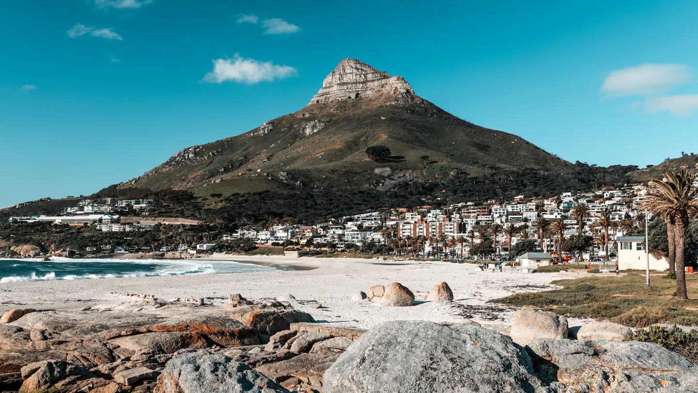 Lion's Head rising above the white sand of Camps Bay beach in Cape Town