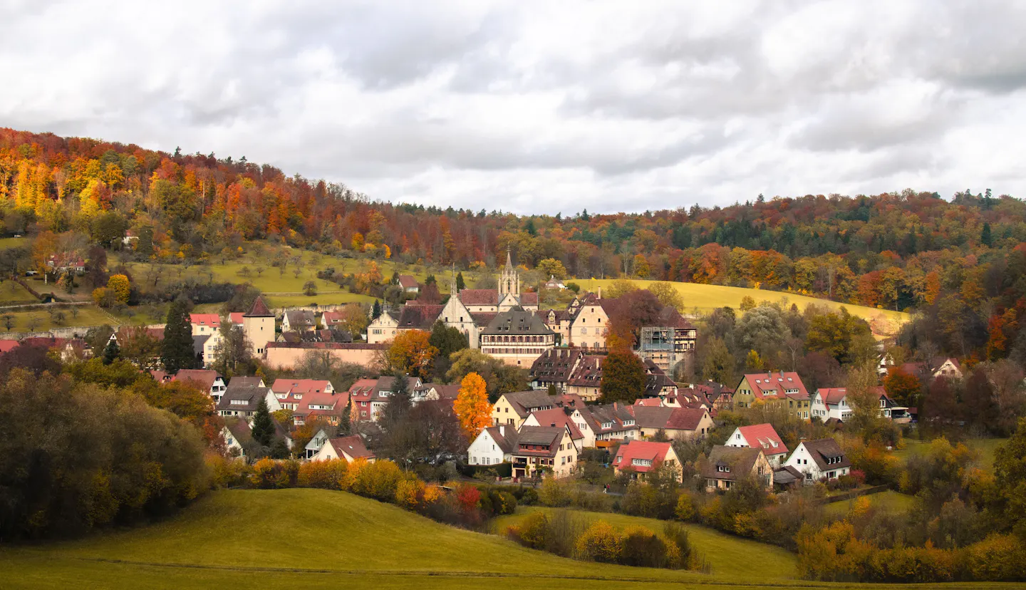 A small village among colourful autumn forests and rolling farmland