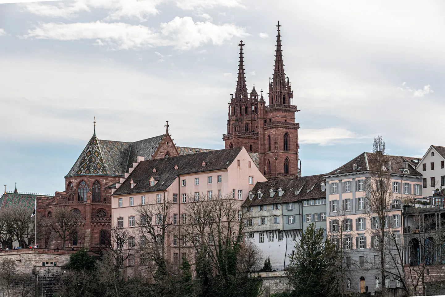 The red sandstone towers and patterned tile roof of Basel Minster above the old town