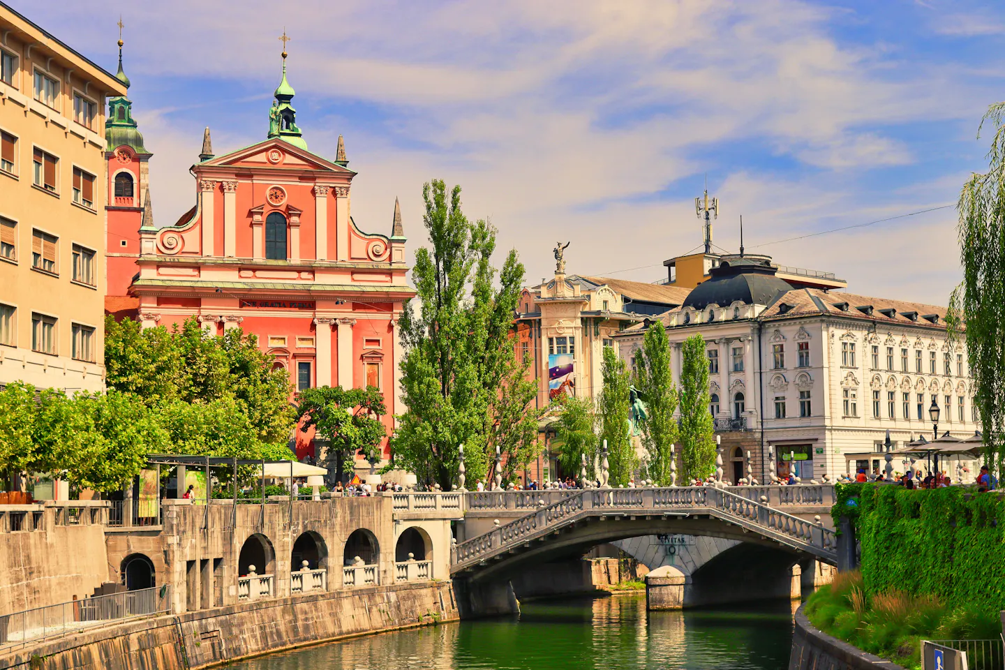 The pink Franciscan Church beside the Triple Bridge over the Ljubljanica river in Ljubljana