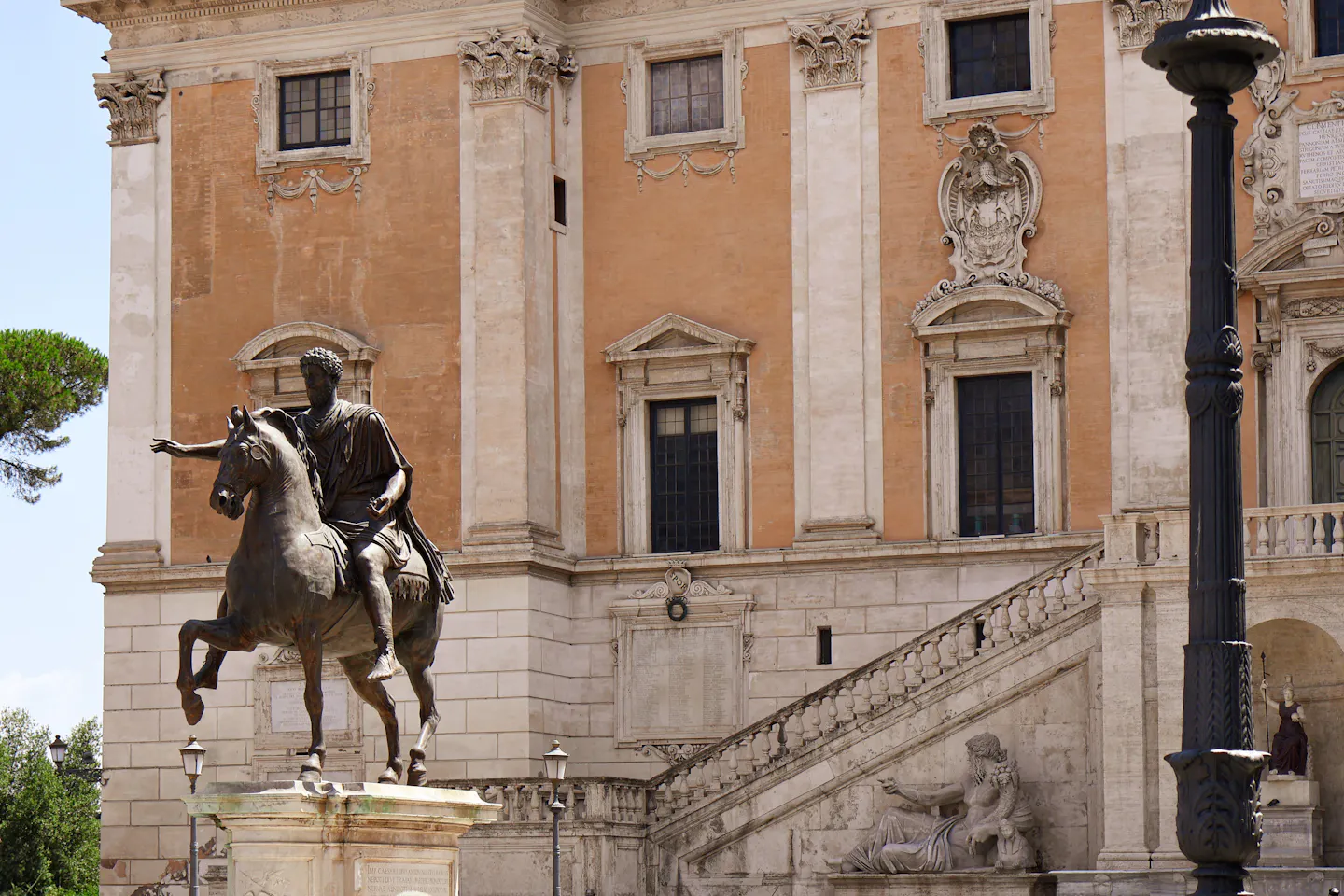 The bronze equestrian statue of Marcus Aurelius in front of the ochre facade and staircase of Palazzo Senatorio on Capitoline Hill