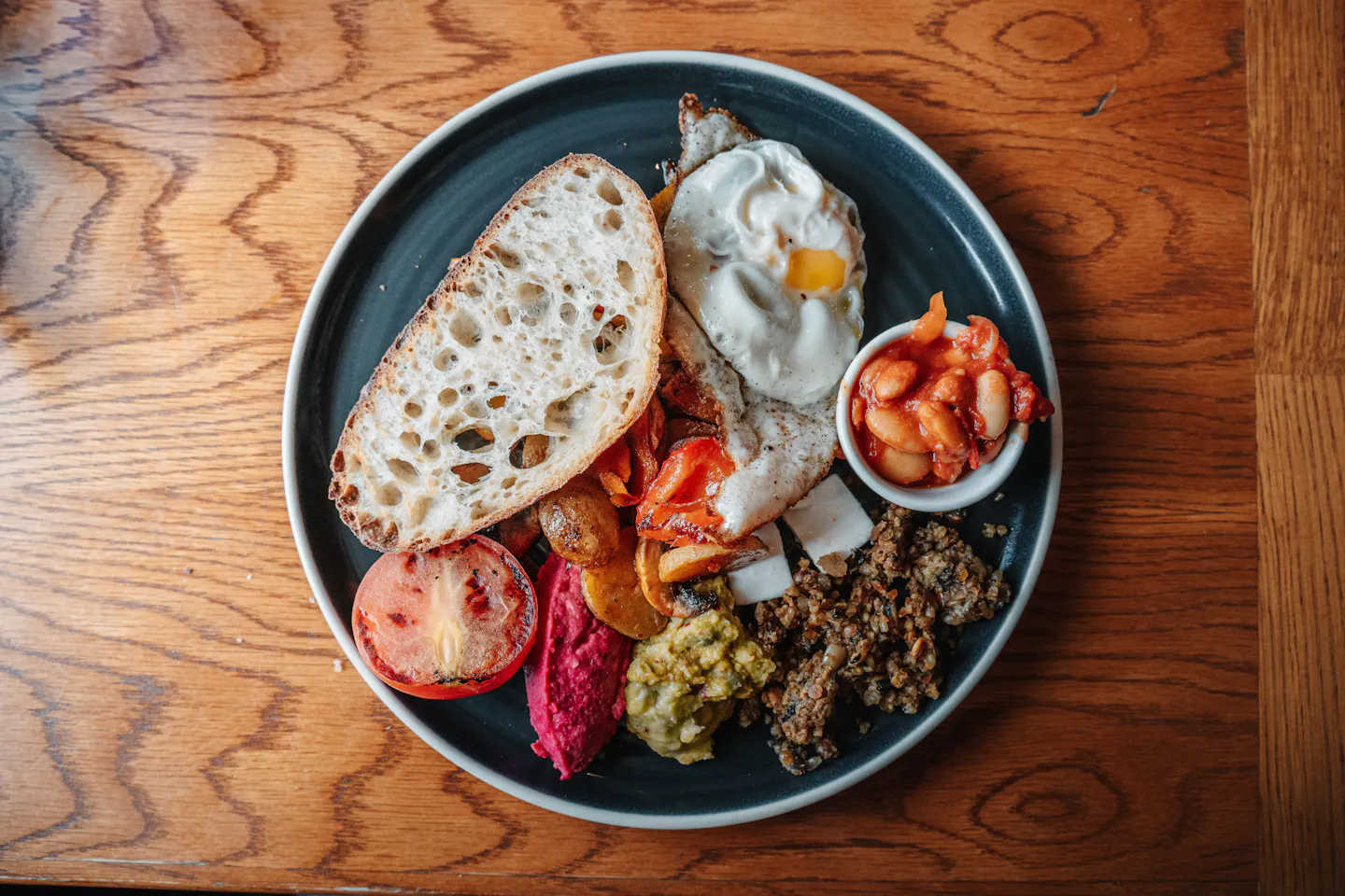 A full Scottish breakfast with fried egg, haggis, beans, tomato and sourdough toast