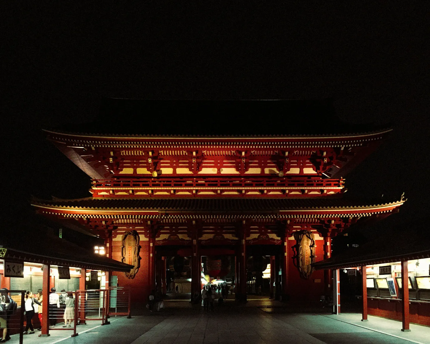 A red temple gate lit at night in Japan