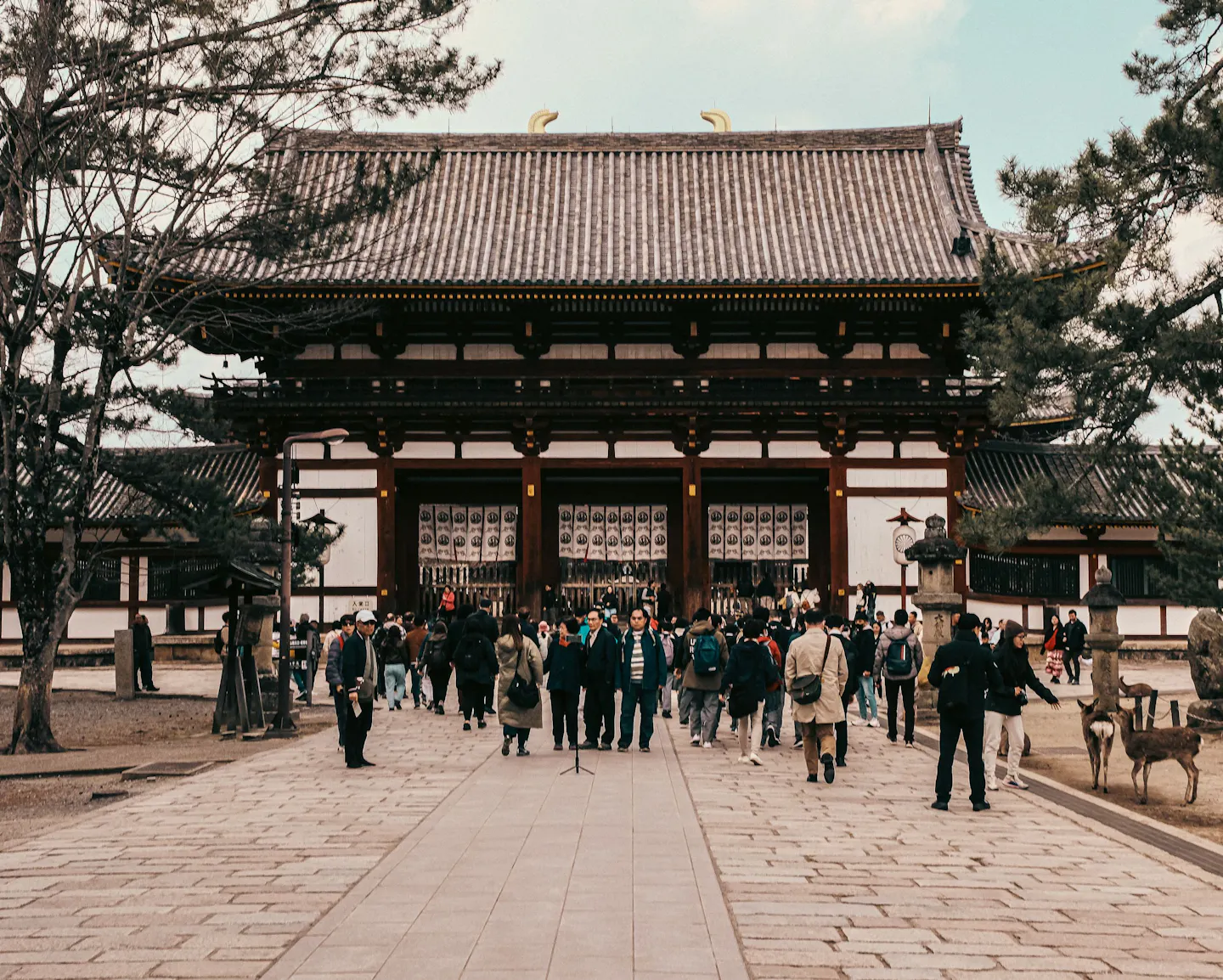 A traditional Japanese temple facade with visitors
