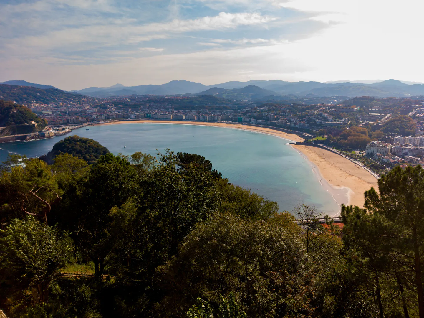The curved sweep of La Concha bay and its beach below the green hills of San Sebastian