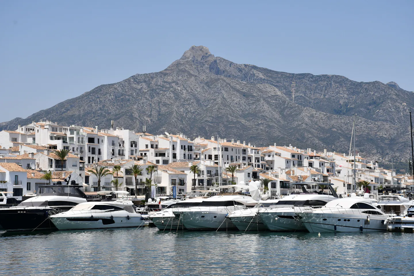 Motor yachts moored at Puerto Banus below the peak of La Concha in Marbella