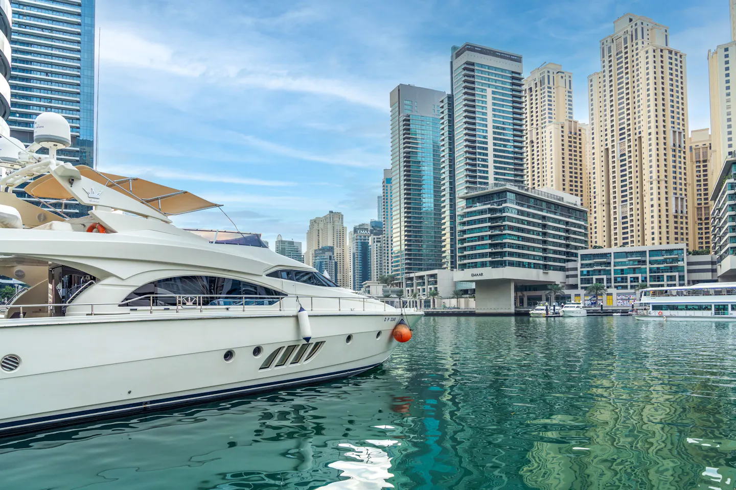 Dubai Marina, with a yacht on the water beneath the city's high-rise skyline