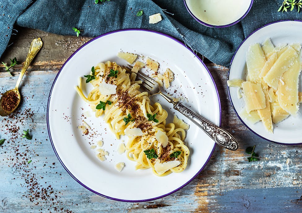 Chitarrine with Parmigiano Reggiano cream, pink pepper and aromatic herbs