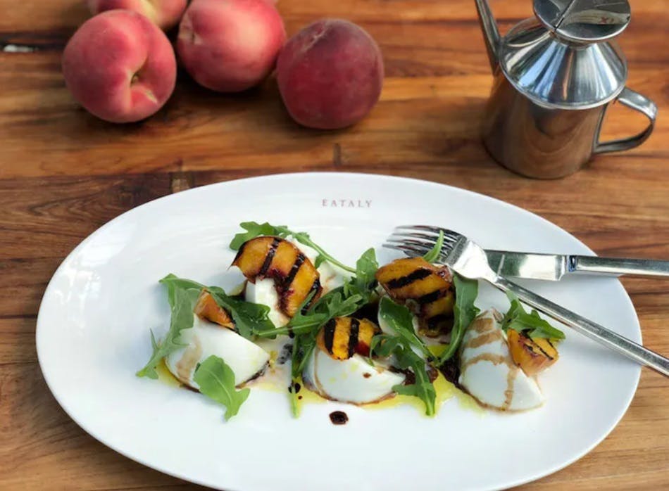 A grilled peach salad with mozzarella and arugula