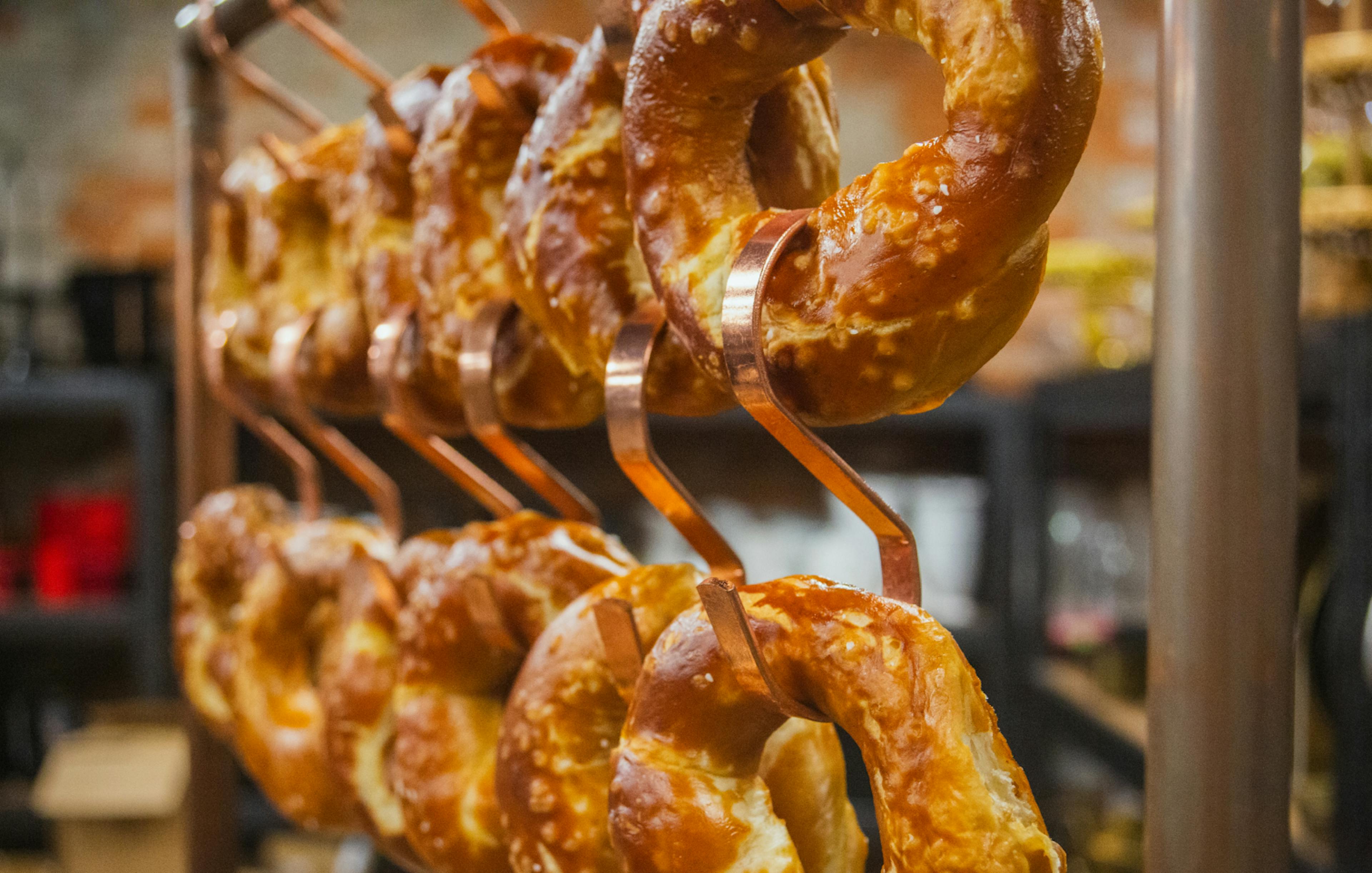 Blue Oven soft pretzels hang on a fun display ready to be enjoyed 