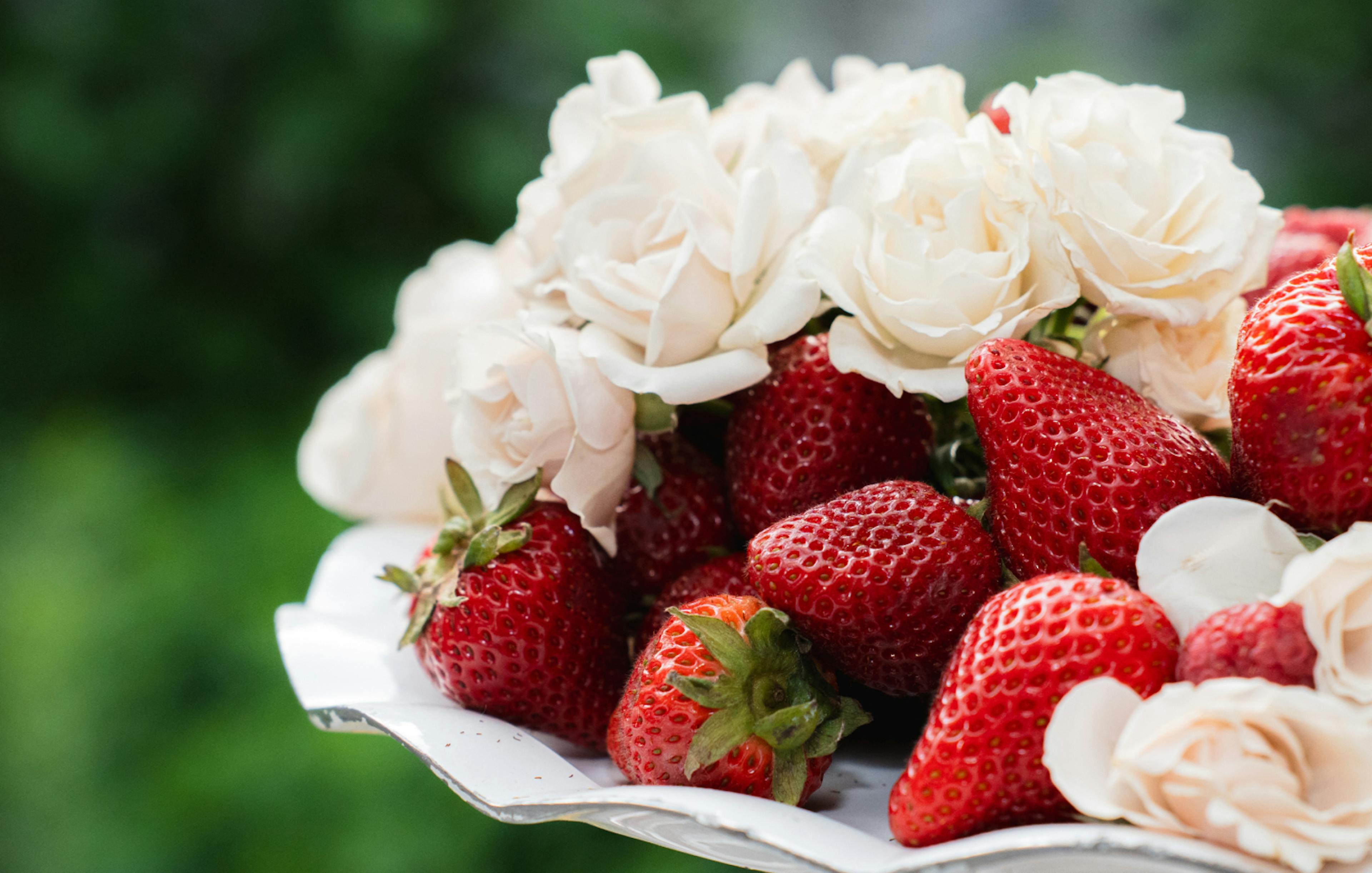 fresh strawberries and small white roses 
