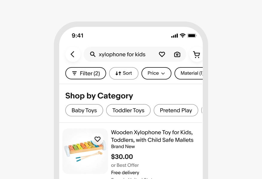 Mobile search results screen for "xylophone for kids" showing a filter bar with four chips: Filter (2), Sort, Price, and Material (1). Below are category quick filter pills for: Baby Toys, Toddler Toys, and Pretend Play.