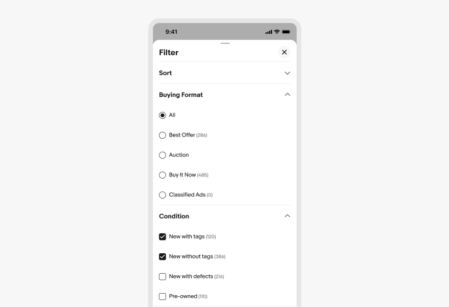 Mobile filter panel with two expanded sections. Buying Format shows radio buttons with All selected, and options for Best Offer, Auction, Buy It Now, and Classified Ads. Condition shows New with tags and New without tags selected checkbox, and New with defects and Pre-owned unchecked.