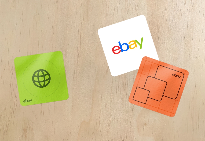 A set of 3 rounded square stickers, one of which is the 4 color logo on white. The other two stickers are green and coral, respectively, with a small tonal logo forced into the corner.