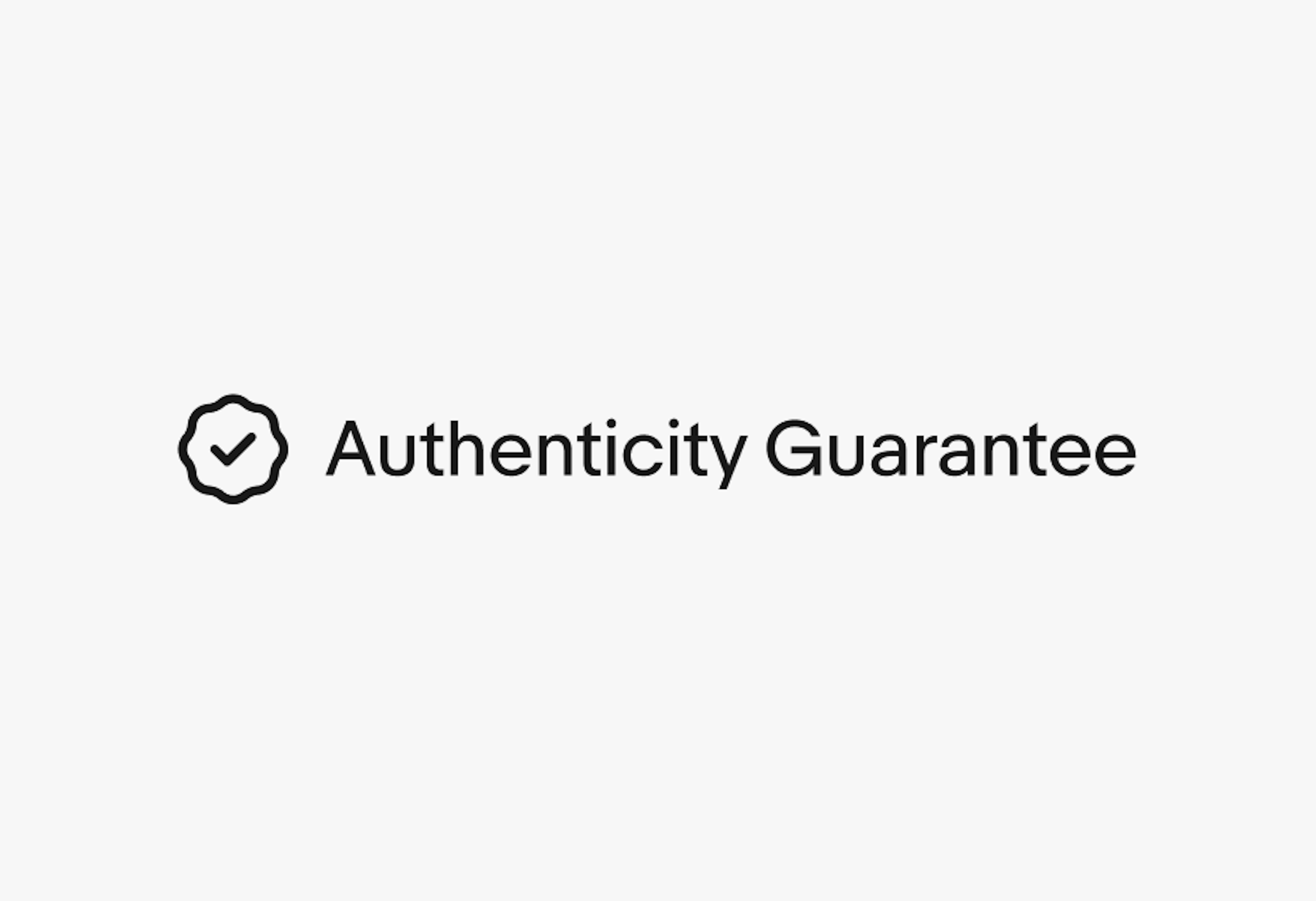 A rosette checkmark icon next to a single line of text “Authenticity Guarantee”.