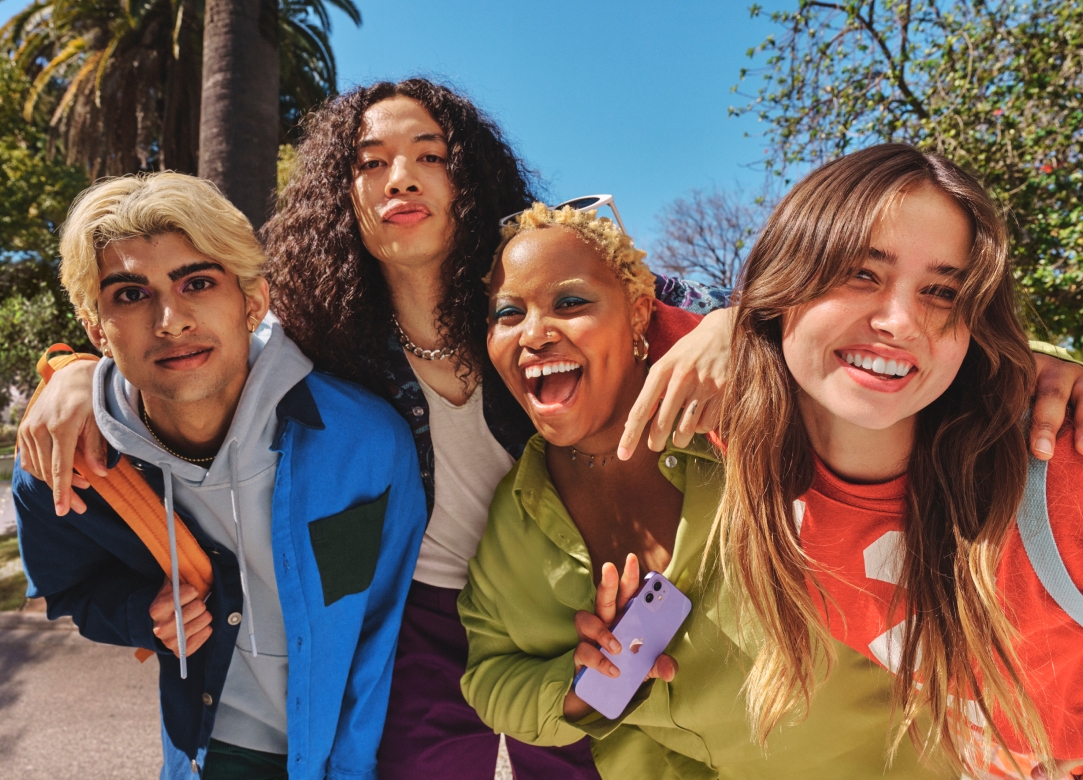 A diverse group of four friends taking a selfie in Los Angeles on a sunny day.