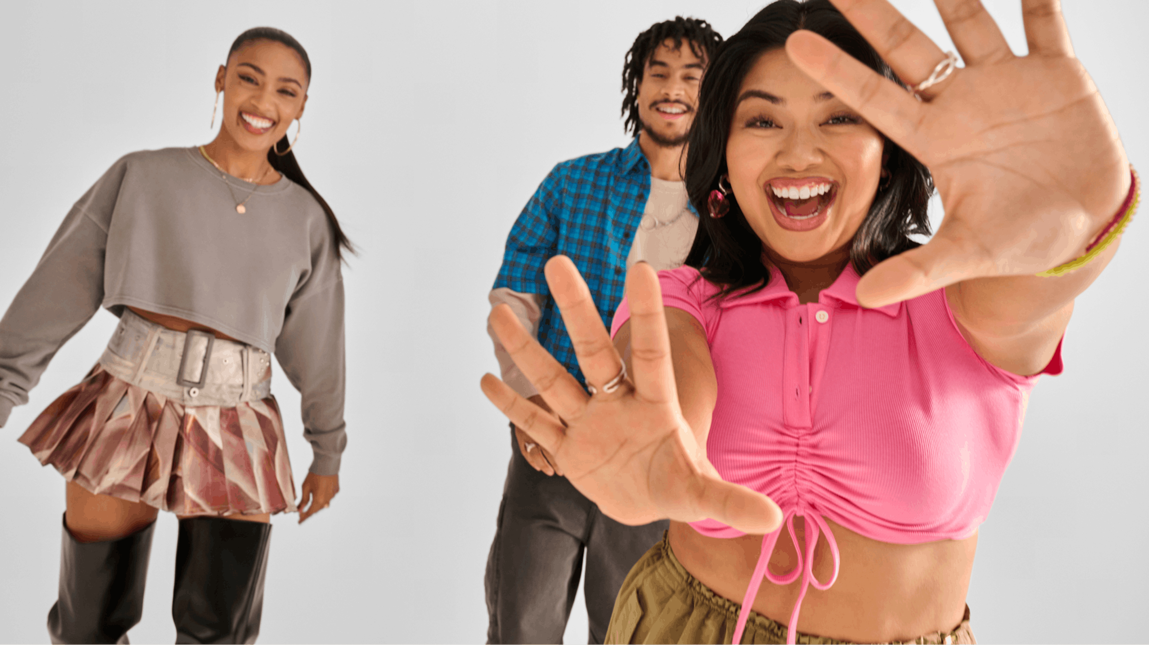 The image shows three young adults posing in a white seamless studio, wearing preloved clothing. Asian girl is showing her hands in a playful way.