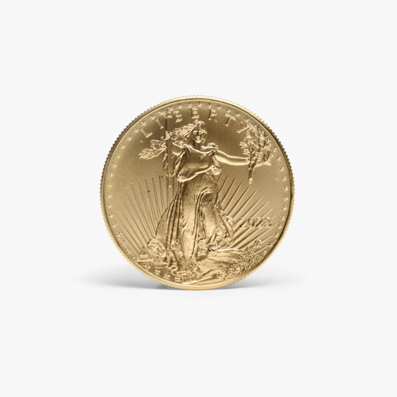 The image shows a gold coin with shadow behind it featuring the figure of Lady Liberty holding a torch and an olive branch, with the word "LIBERTY" and the year "2023" inscribed on it.