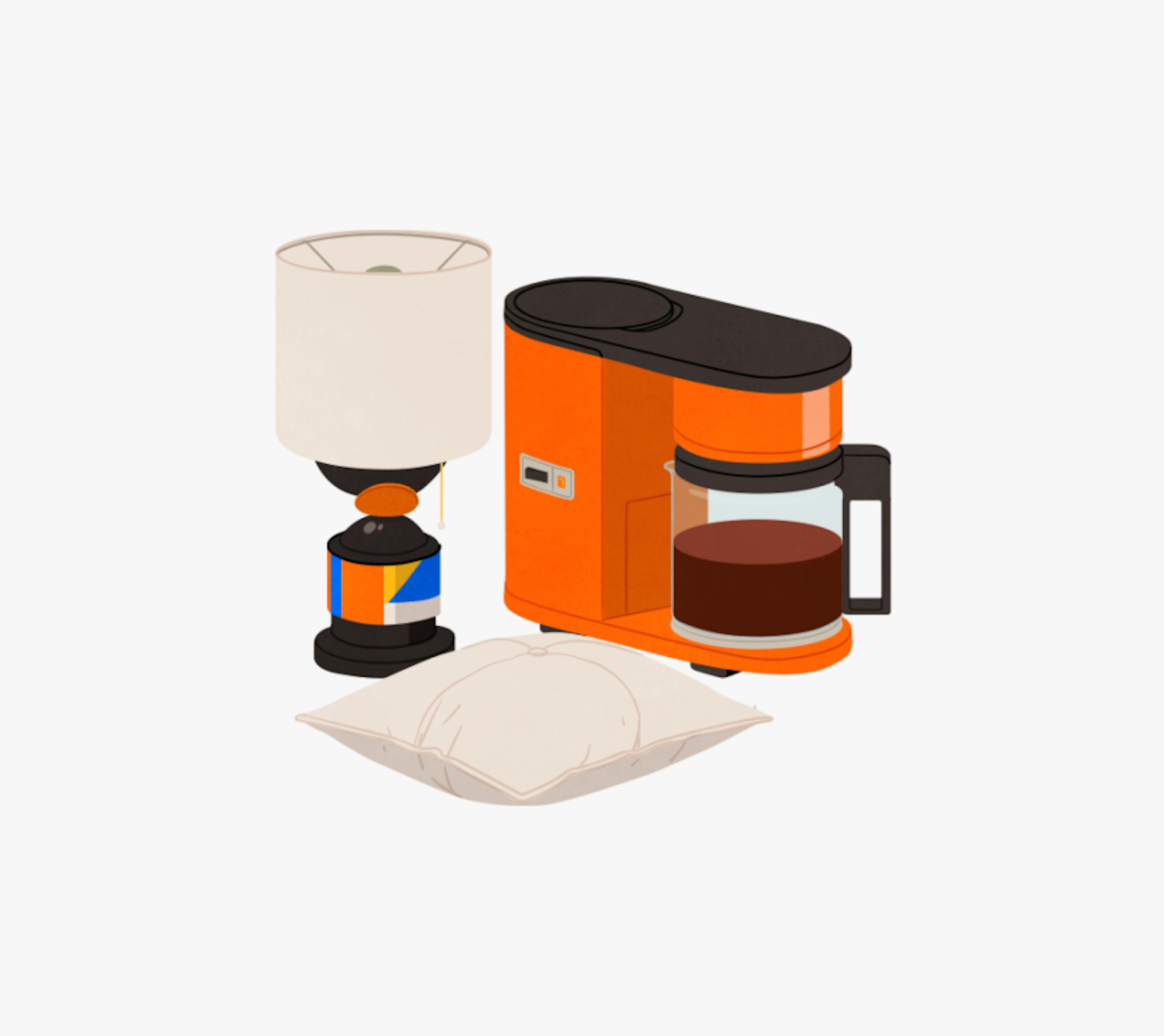 An orange and black coffee maker with a glass carafe, a white table lamp with a colorful base, and a white pillow are arranged together.