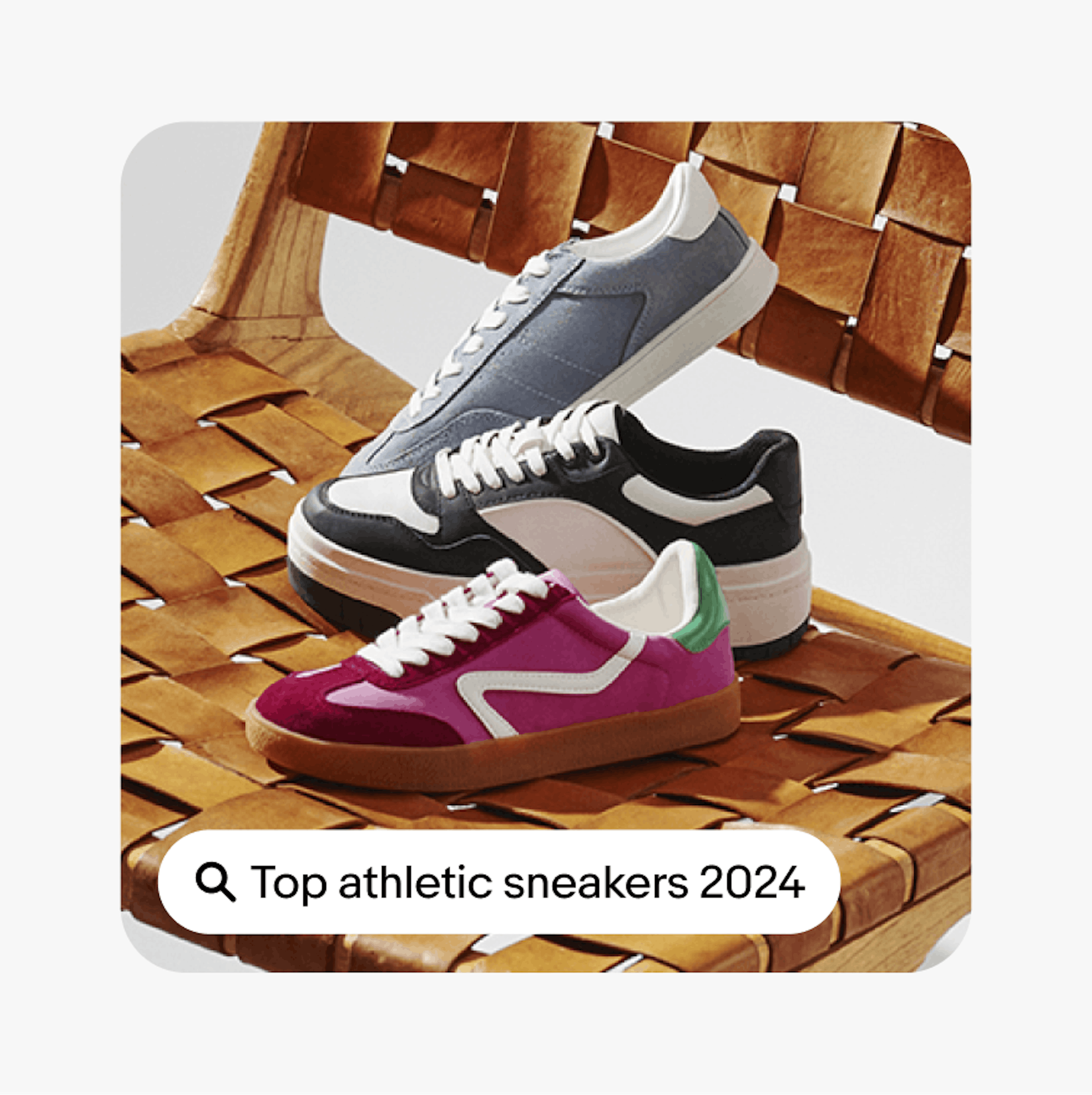 A ‘Top athletic sneakers 2024’ UI Element with a search icon sits on a card with an closeup image of three sneakers sitting on a chair.