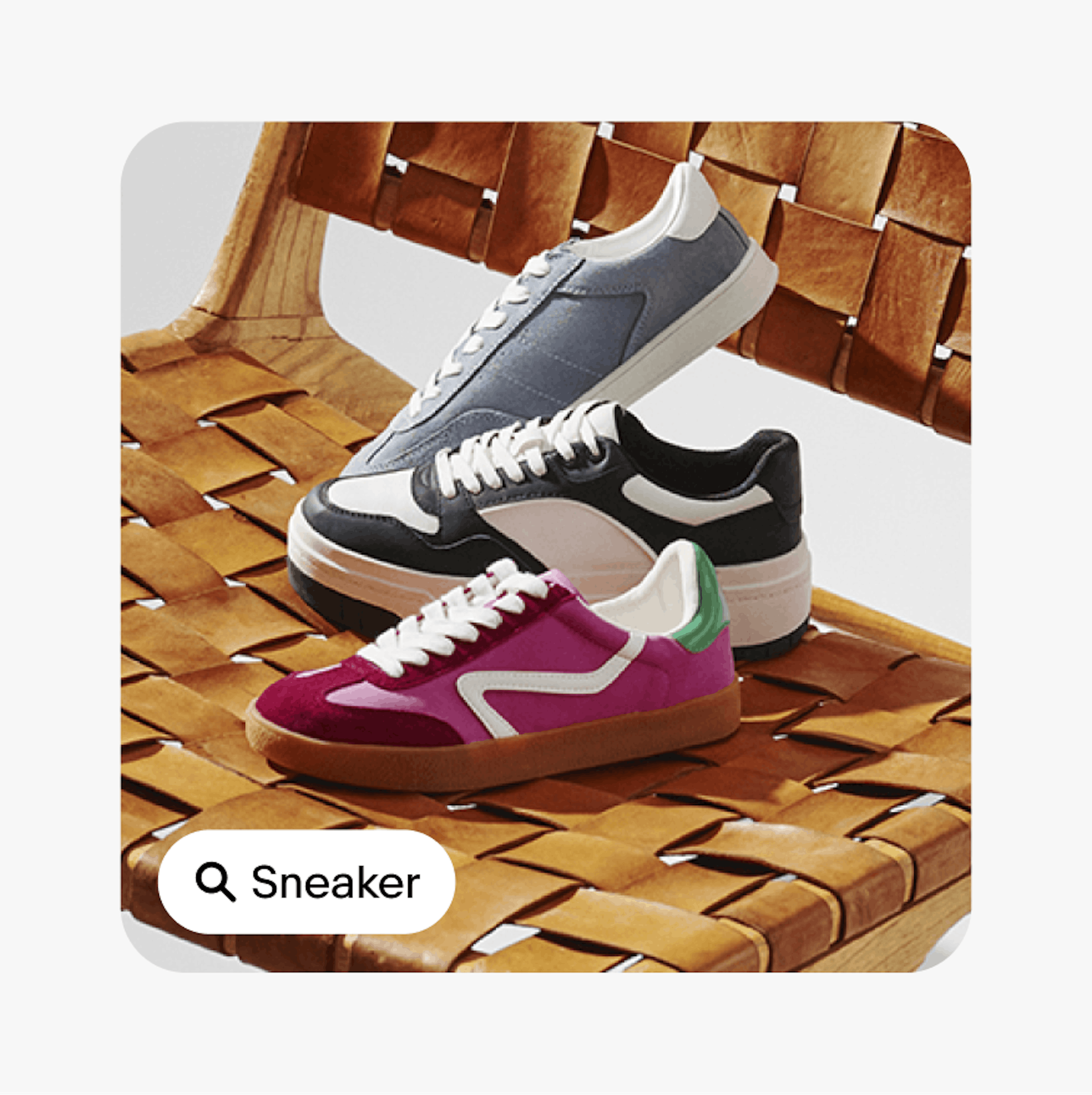 A ‘Sneakers’ UI Element with a search icon sits on a card with an closeup image of three sneakers sitting on a chair.