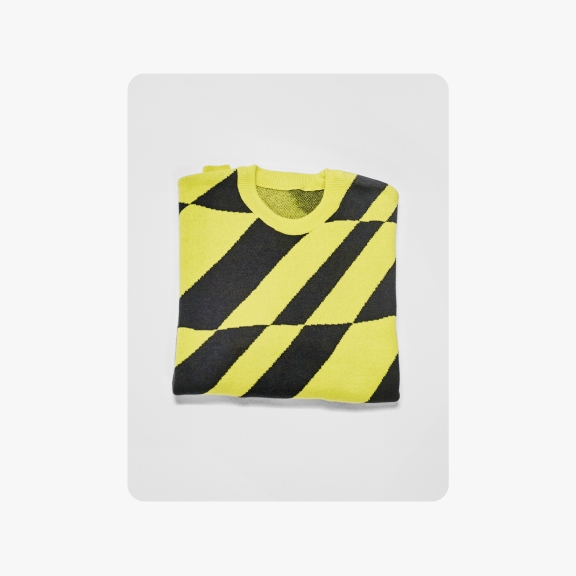 A folded sweater with a bright yellow and black diagonal stripe pattern, displayed on a light grey background with rounded corners.