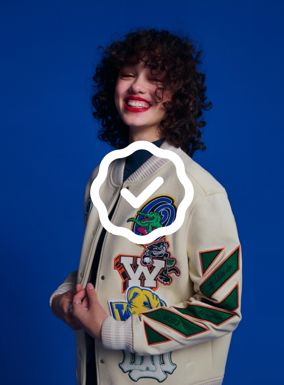 A white program badge sits on top of a studio image of a person wearing street clothes on a dark blue background.