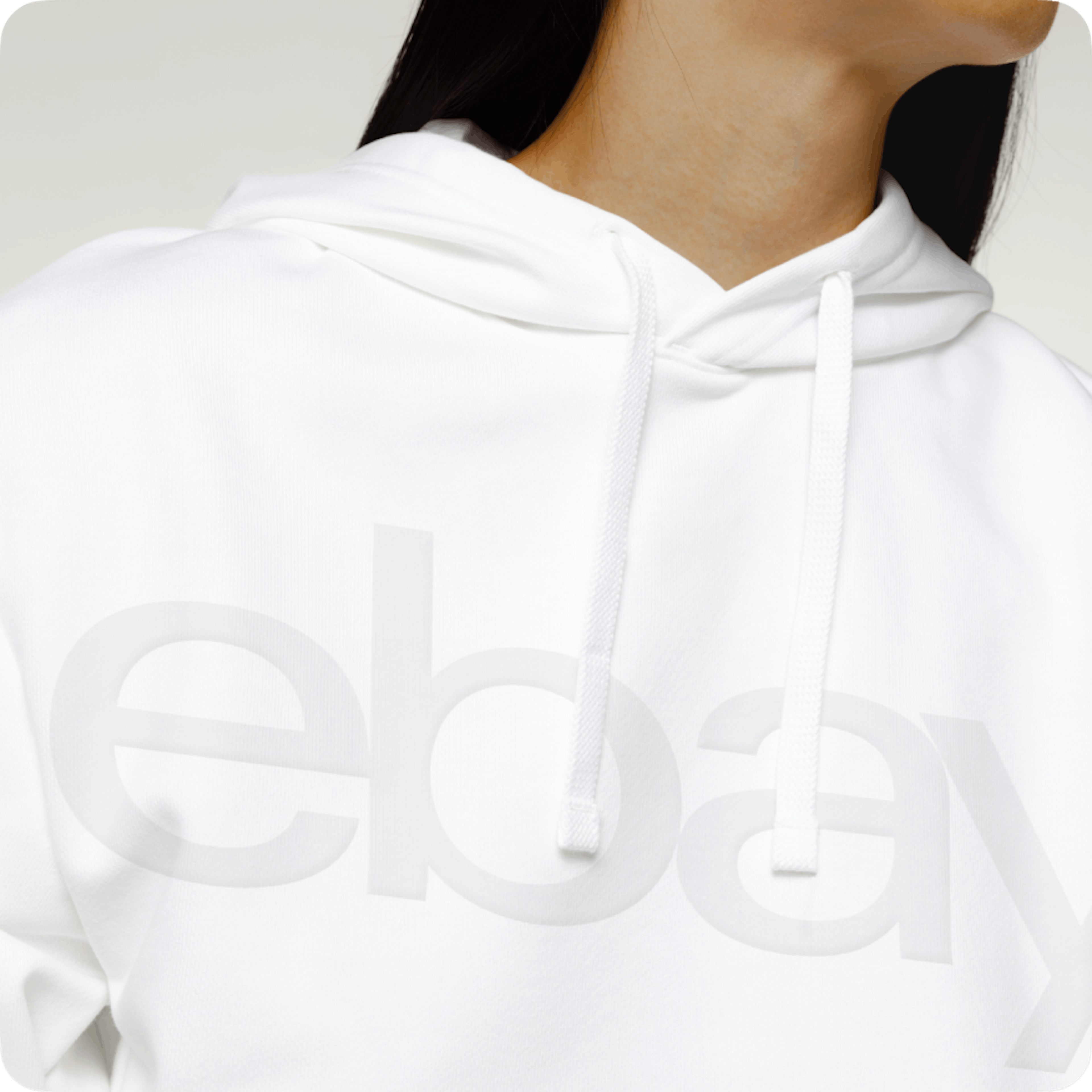 A white, embossed eBay logo on a white hoodie.