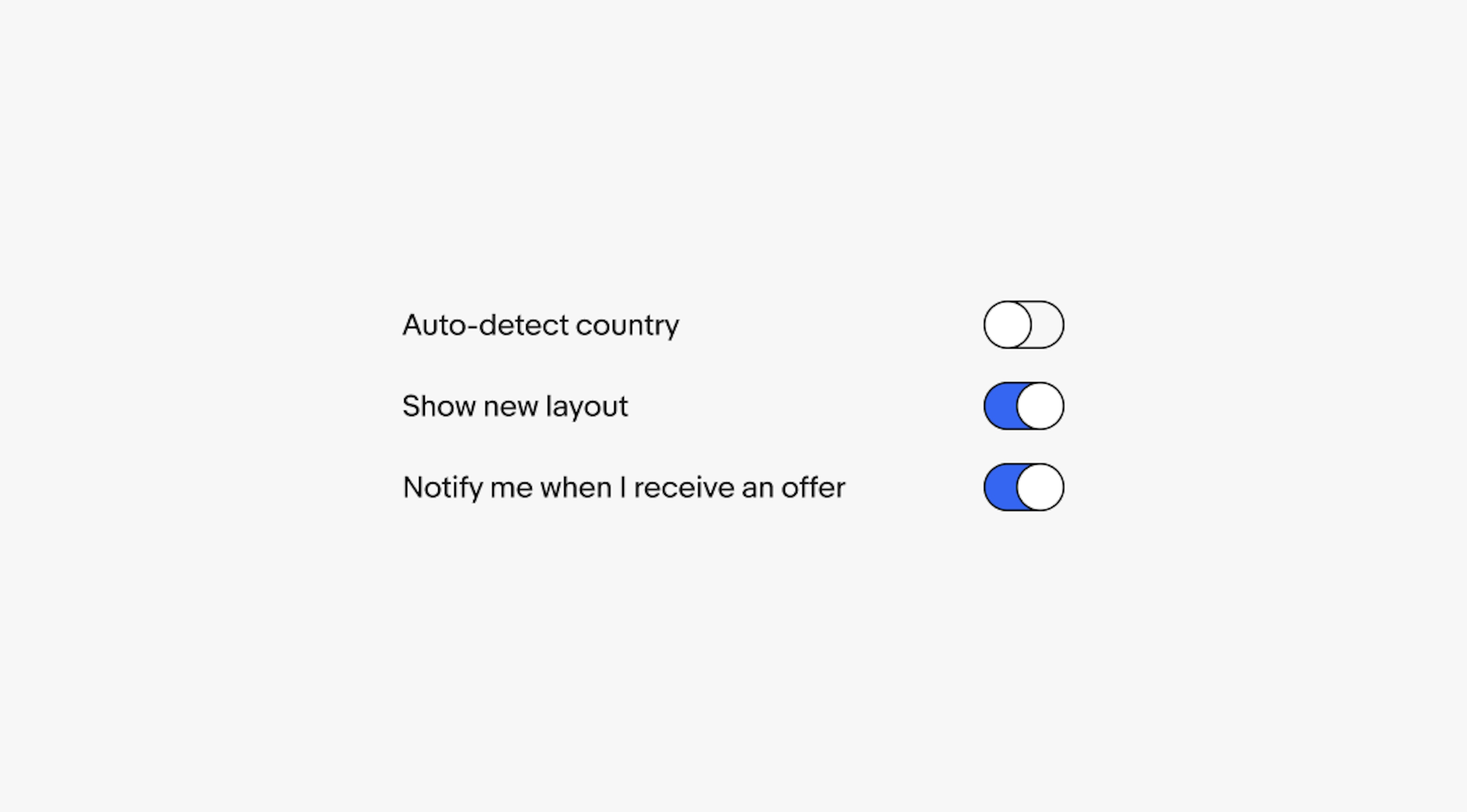 3 switches with labels: ‘Auto-detect country’ with an unselected switch, ‘Show new layout’ with a selected switch, and ‘Notify me when I receive an offer’ with a selected switch.