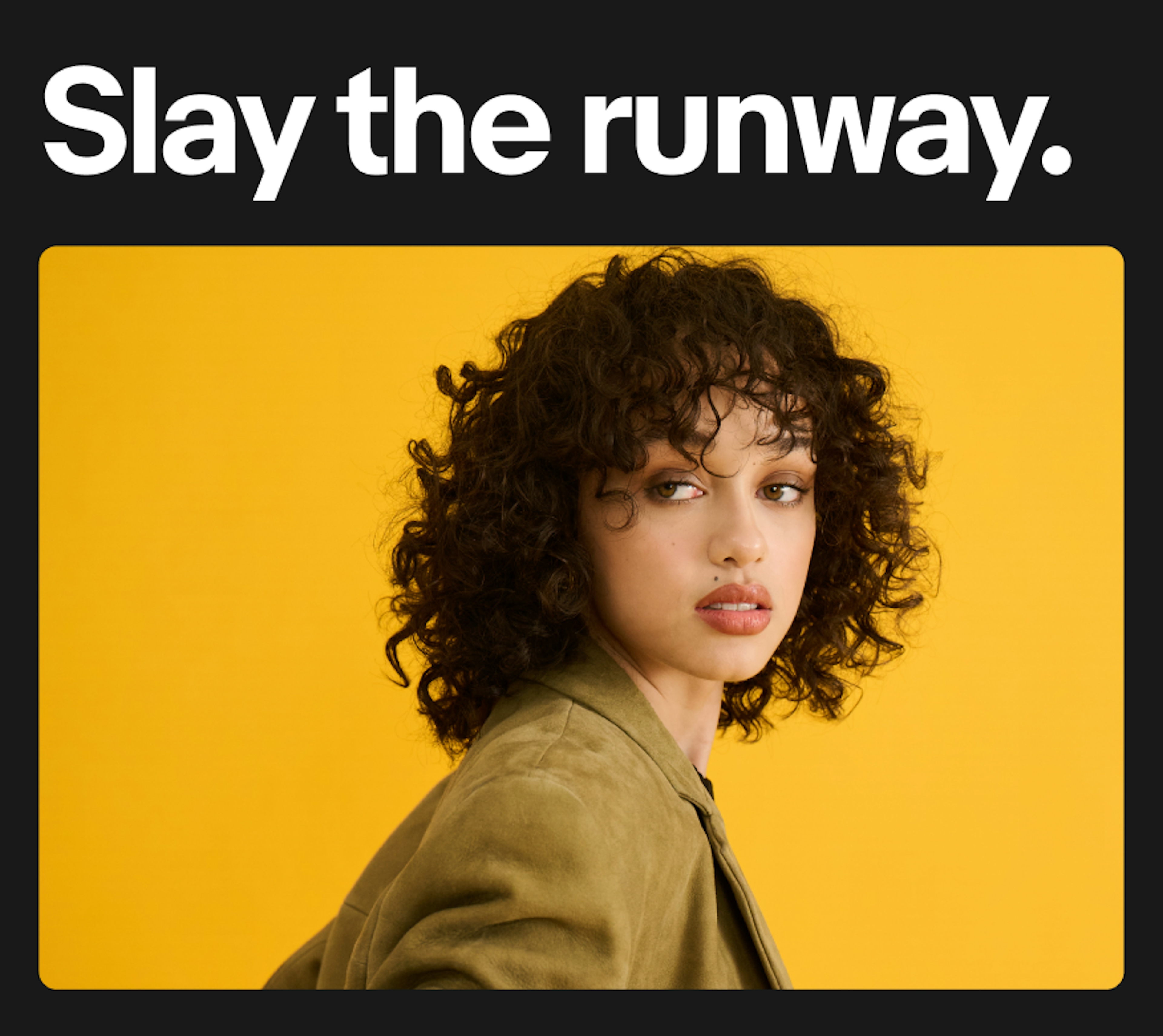 White text and a studio image of a person standing in front of an orange backdrop sits on a black background.