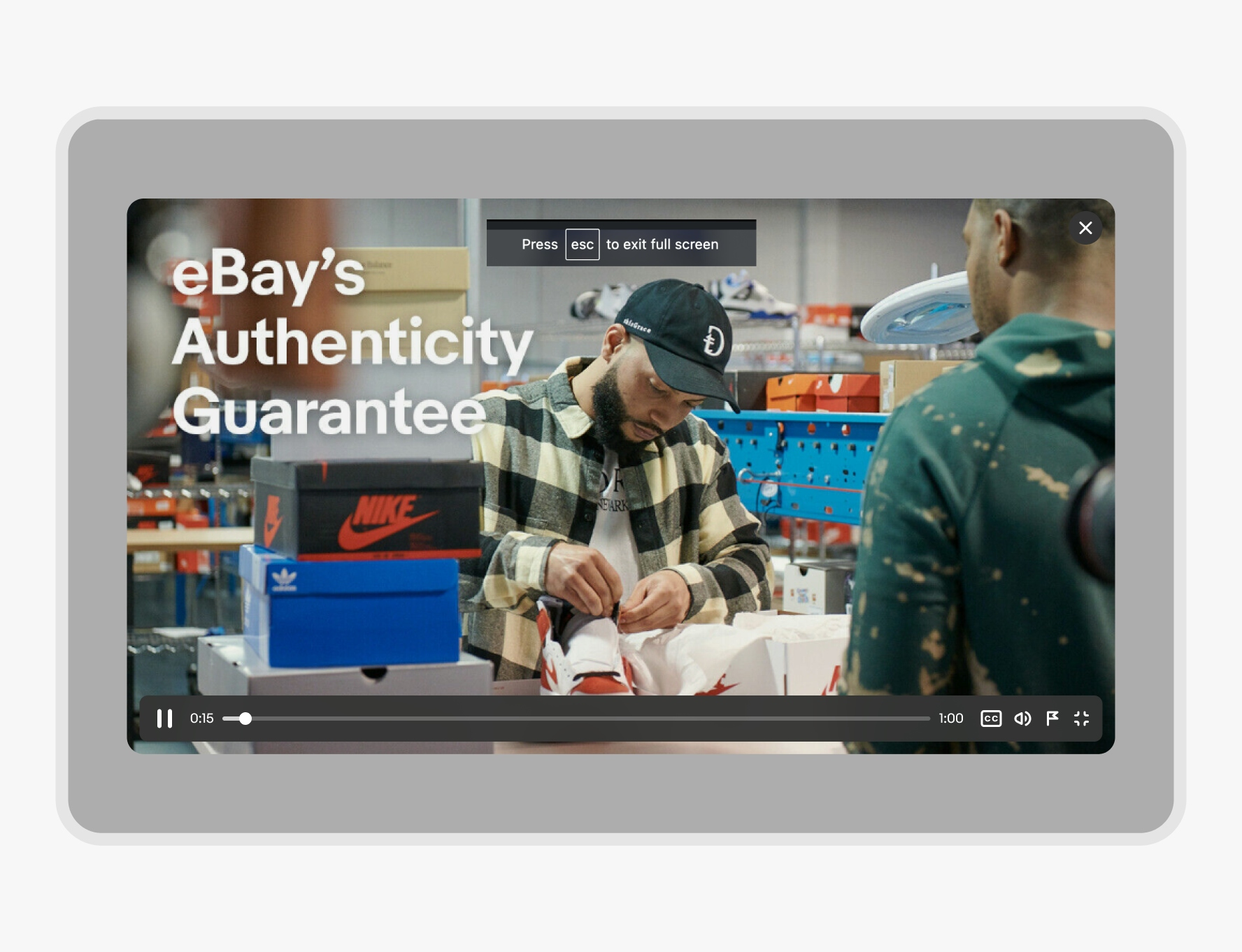 A video player is on web overlaid on a scrim. A close icon button is situated on the top right of the screen.