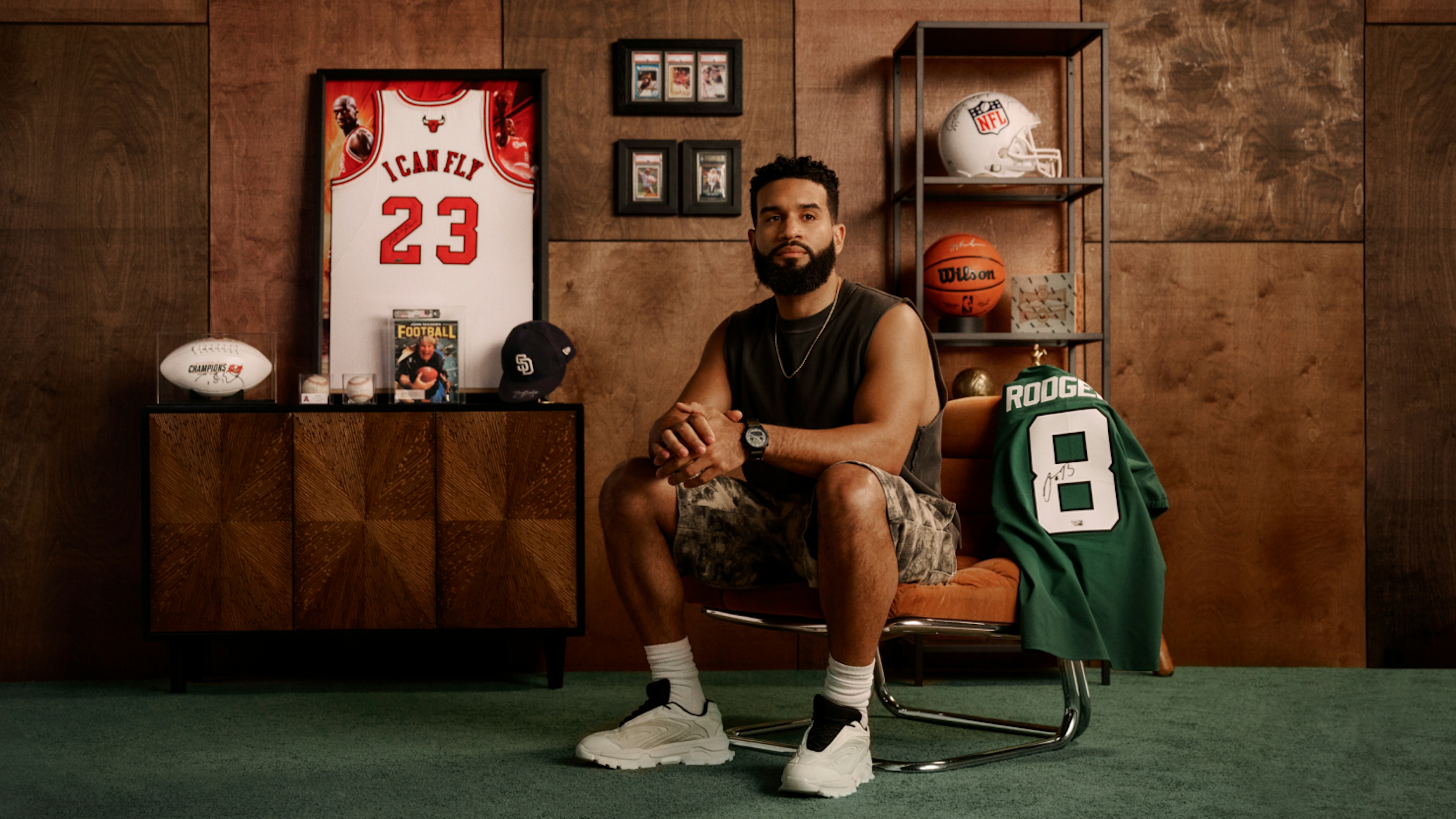 An image of a male customer sitting among highly coveted sports memorabilia bought on eBay.