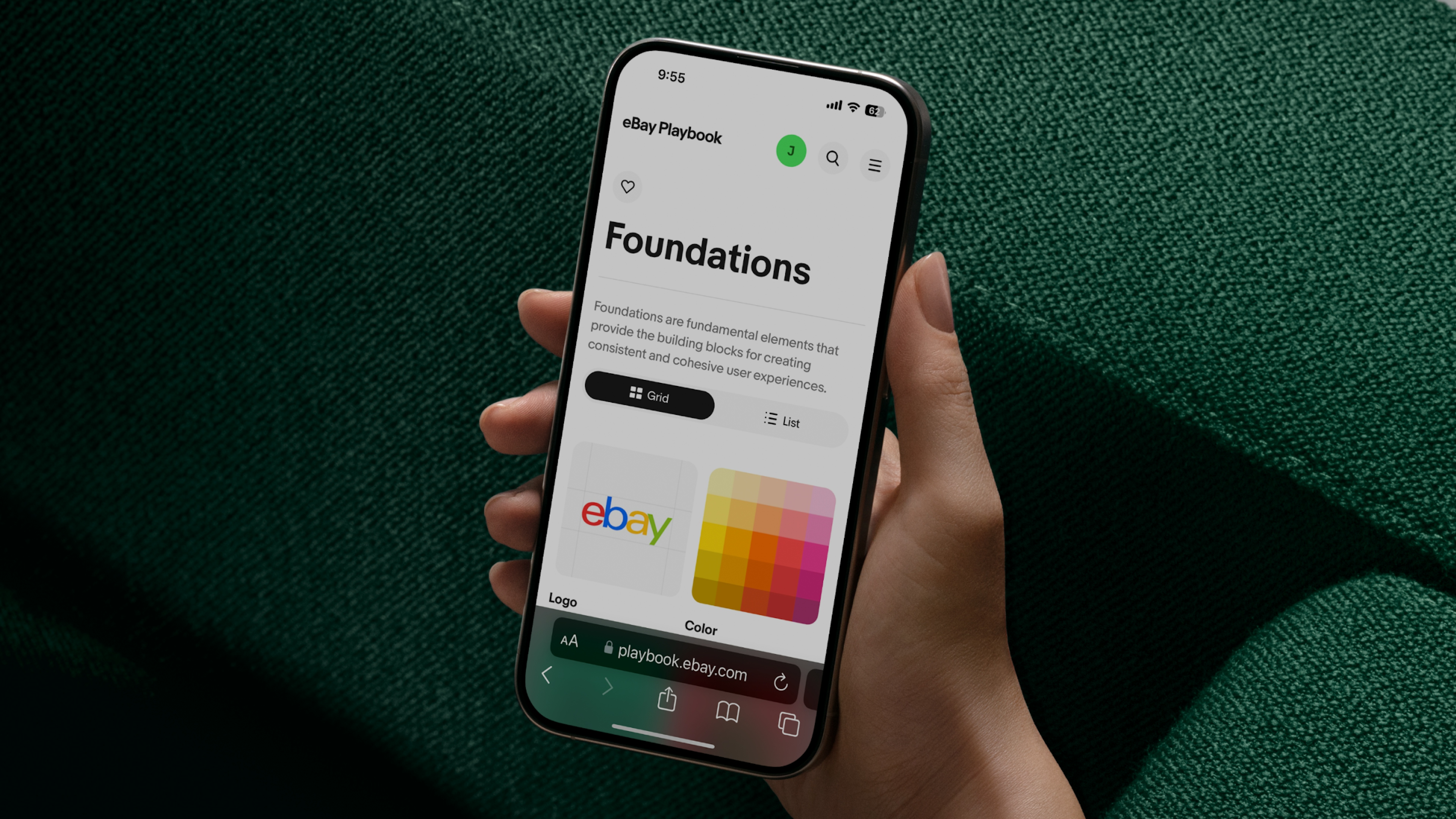 A visual of a hand holding a phone. The phone is showing the foundations page of the eBay Playbook website.