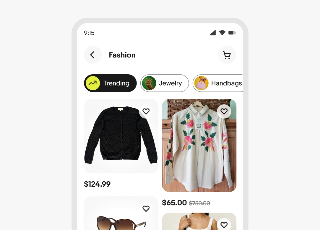 A fashion page with Discovery chips at the top, including Trending, Jewelry, and Handbags. Below, items like a pair of speakers, a denim jacket, headphones, and white athletic shorts are shown in a grid, each with a price and a heart icon for favoriting.