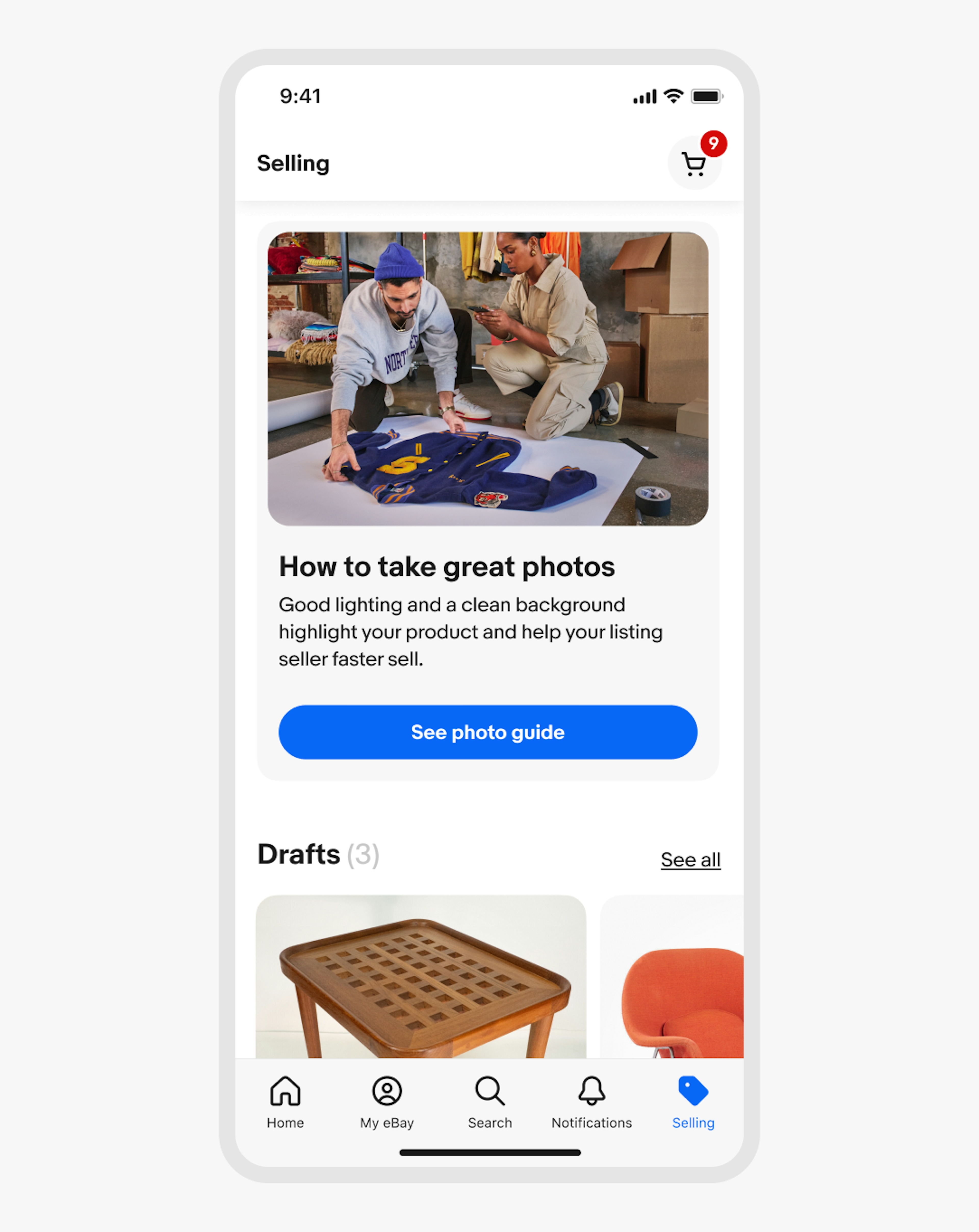 A phone screen titled “Selling” with a vertical card with a light grey background. The card has a photo of two people taking a photo of a jacket, a title labeled “How to take great photos”, body copy, and a primary CTA button labeled “See photo guide”. Below is a section labeled “Drafts (3)” with two images. 