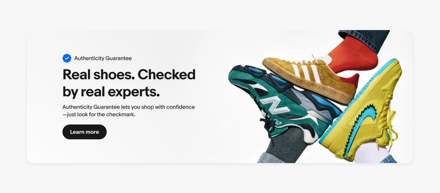 A large product banner with text on the left side containing an overline, headline, subline, and cta button. The image contains a neutral background with 3 types of shoes. The overline has the program lockup for Authenticity Guarantee.