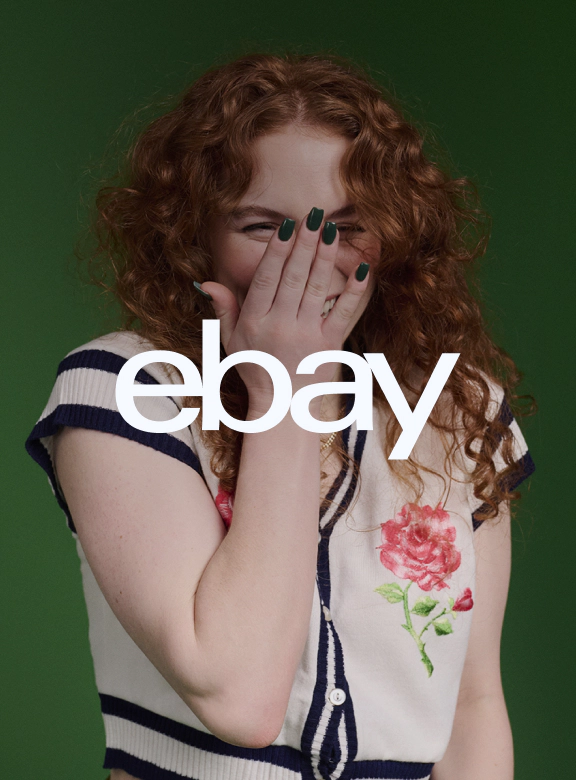 A white eBay logo, on top of an image of three people.