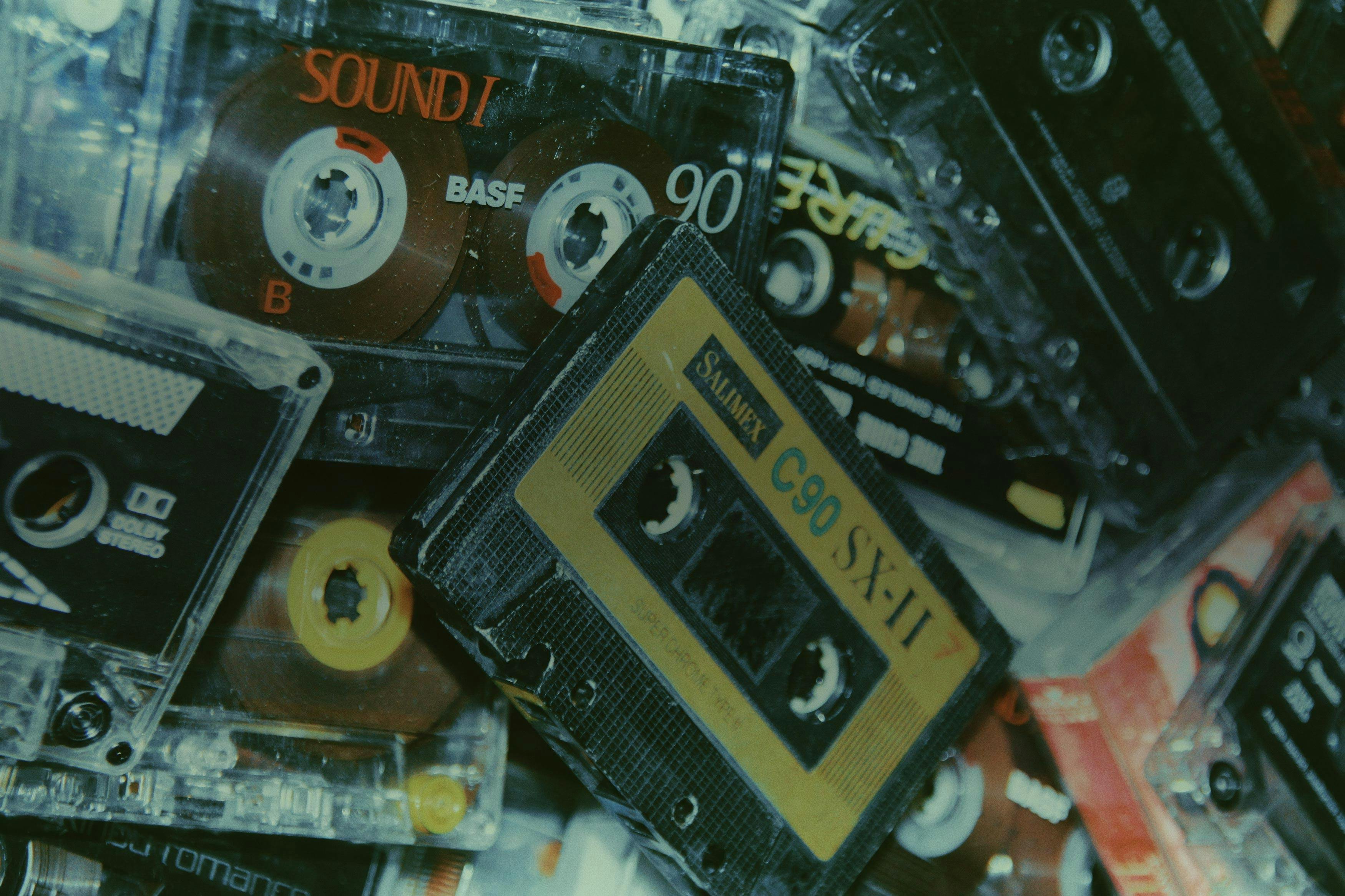 piles of cassette tapes with demo songs on them