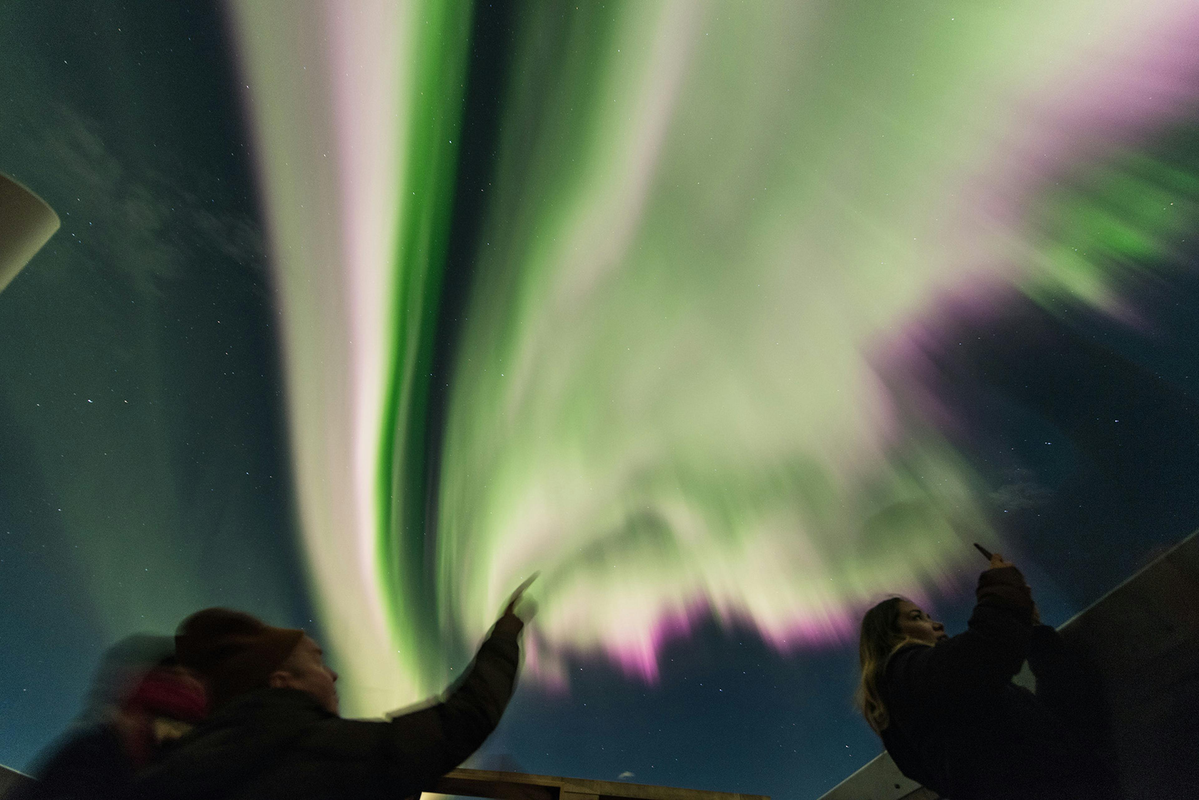 People observing a geomagnetic storm at night from Hotel Rangá. Credit: Sævar Helgi Bragason