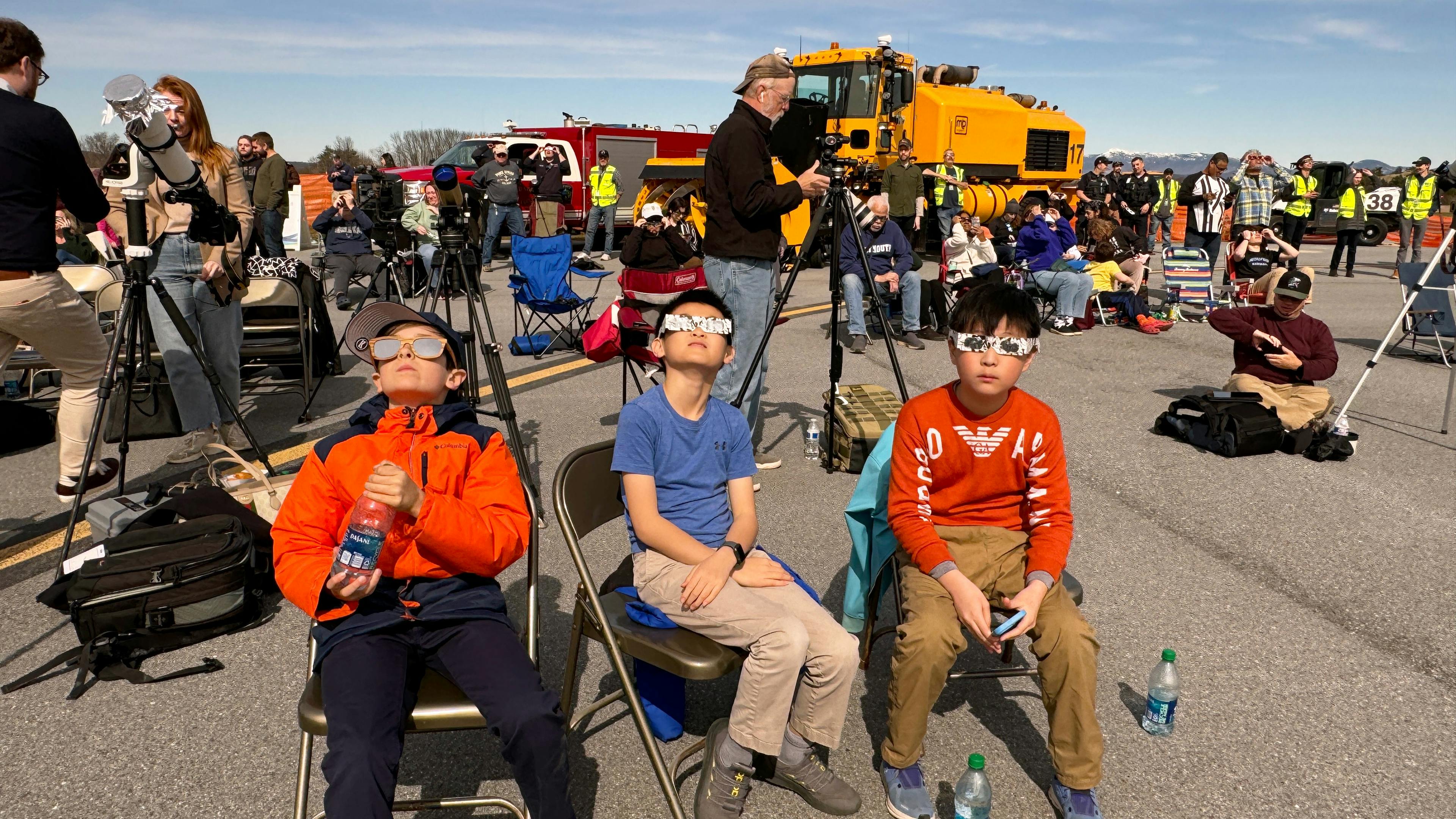 Curious kids watching partial eclipse using safe solar eclipse glasses. Credit: Sævar Helgi Bragason