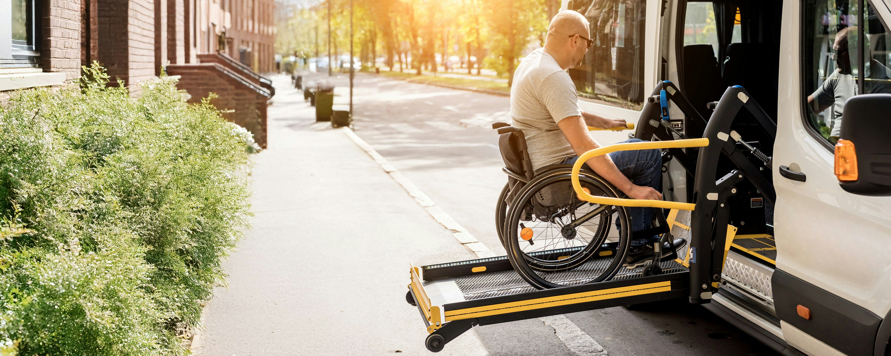 Man in wheelchair getting into accessible vehicle