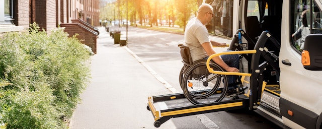 Man in wheelchair getting into accessible vehicle
