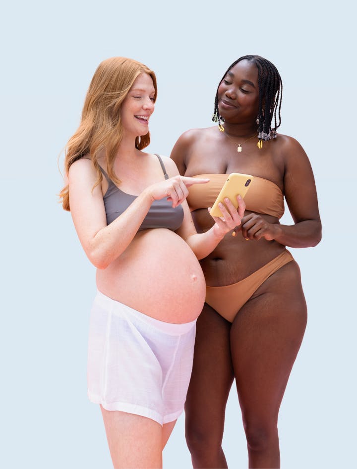 Two women discussing something on a smartphone