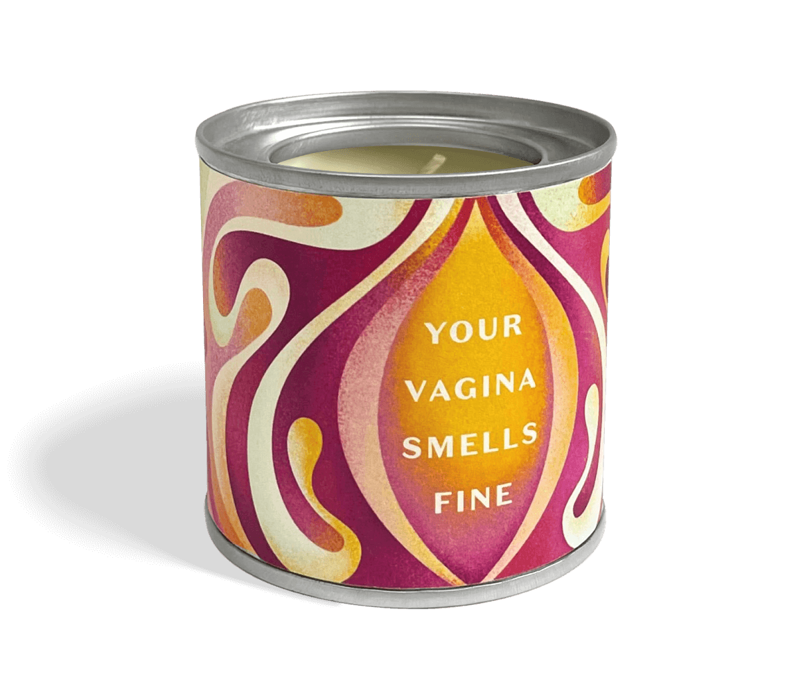 a photo of the your vagina smells fine candle which is housed in an aluminium tin with a sticker that is violet orange and cream  